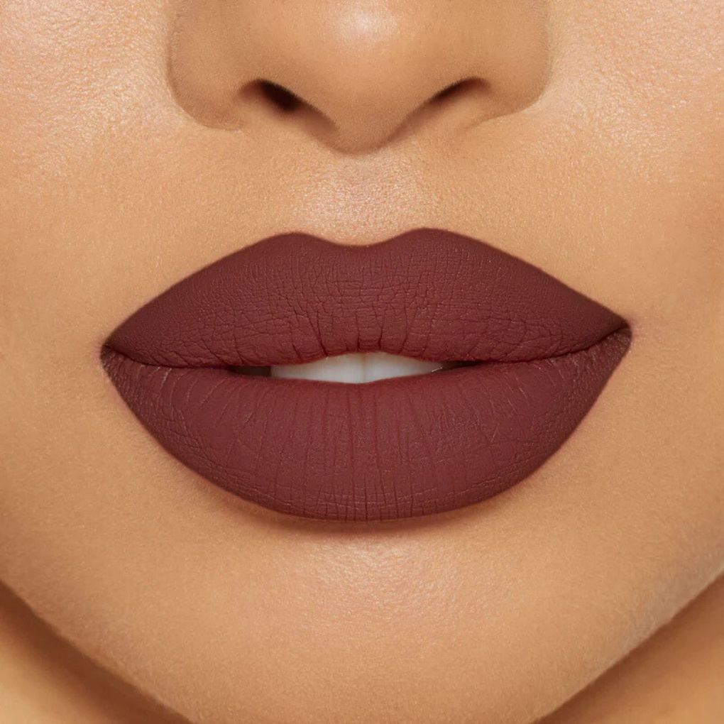 Close-up of model wearing oplenza Icon Matte Lipstick in shade 05 Cocoa Icon, best matte lipstick for dry lips.