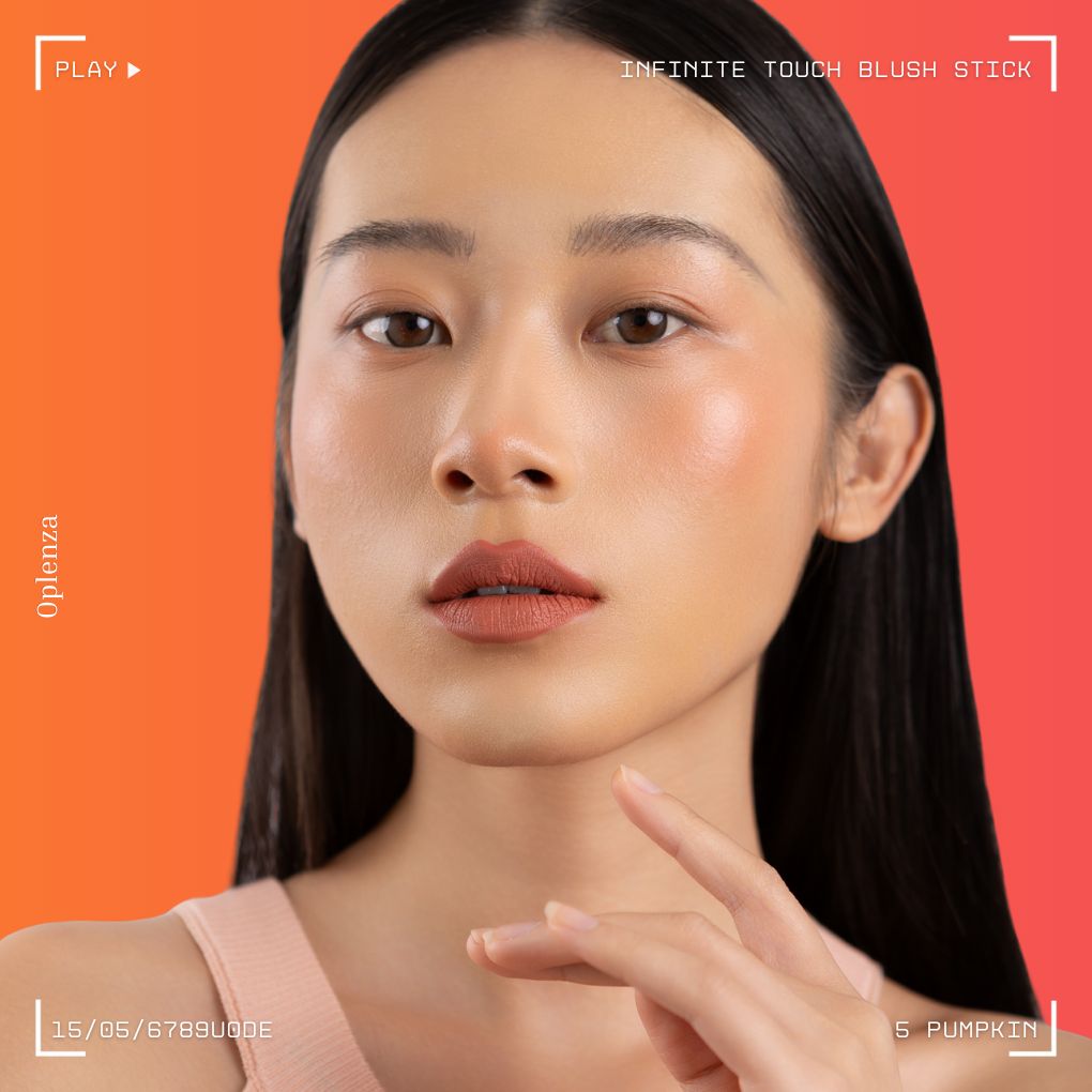 A woman wearing on her cheek Oplenza highly pigmented, bold color dewy Blush Stick in shade 05 Pumpkin