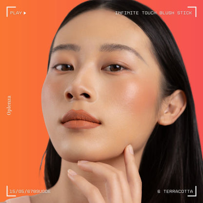 A woman wearing on her cheek Oplenza highly pigmented, bold color dewy Blush Stick in shade 06 Terracotta