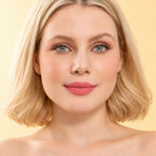 Model wearing Oplenza Signature Longwear Matte Lipstick in 08 Coraline, showing nude orange peach matte lips.