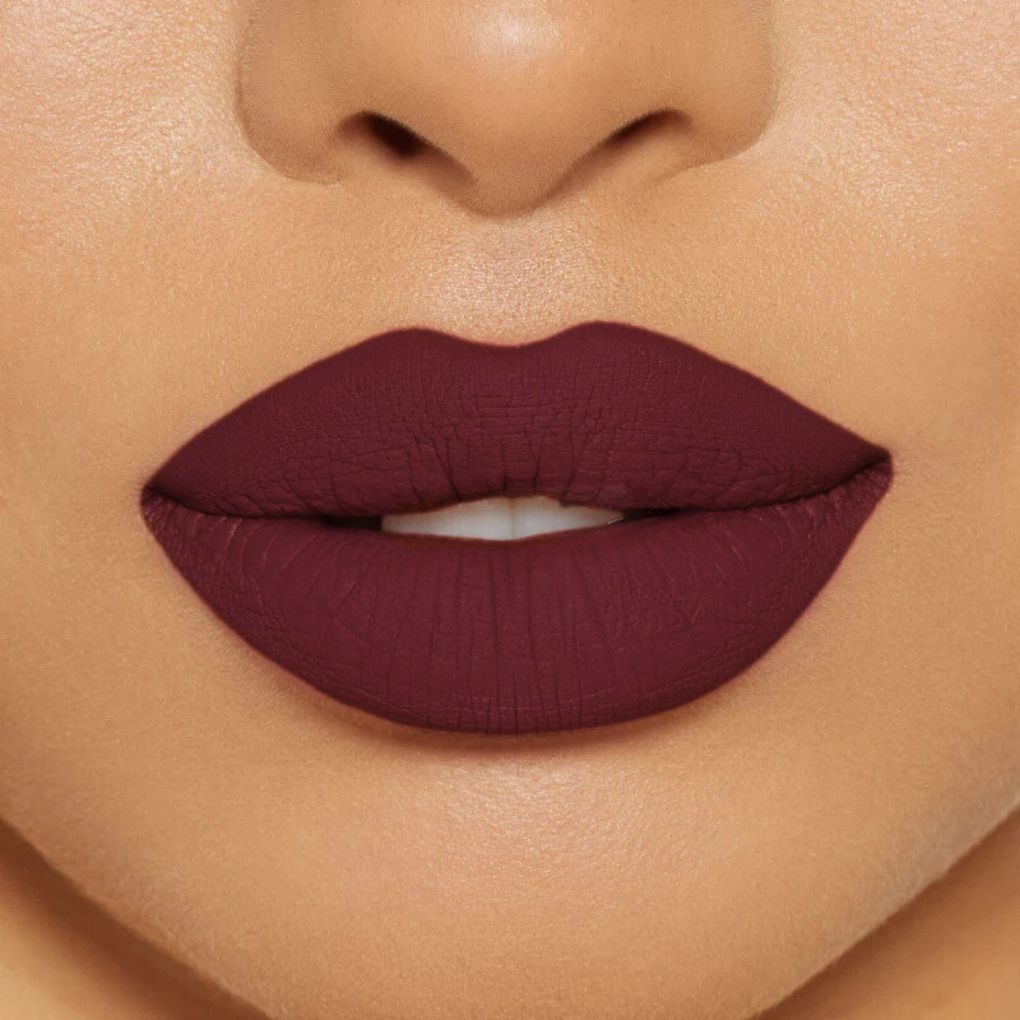 Close-up of model wearing oplenza Icon Matte Lipstick in shade 08 Wine Icon, best matte lipstick drugstore.
