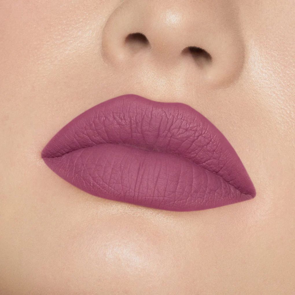 Close-up of model wearing oplenza Icon Matte Lipstick in shade 09 Plum Icon, best matte lipstick
