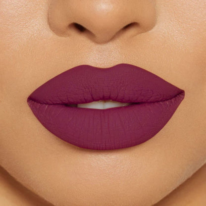 Close-up of model wearing oplenza Icon Matte Lipstick in shade 09 Plum Icon, best matte lipstick for brown skin.