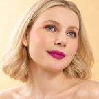Model wearing Oplenza Signature Longwear Matte Lipstick in 09 Violette , showing magenta matte lips.