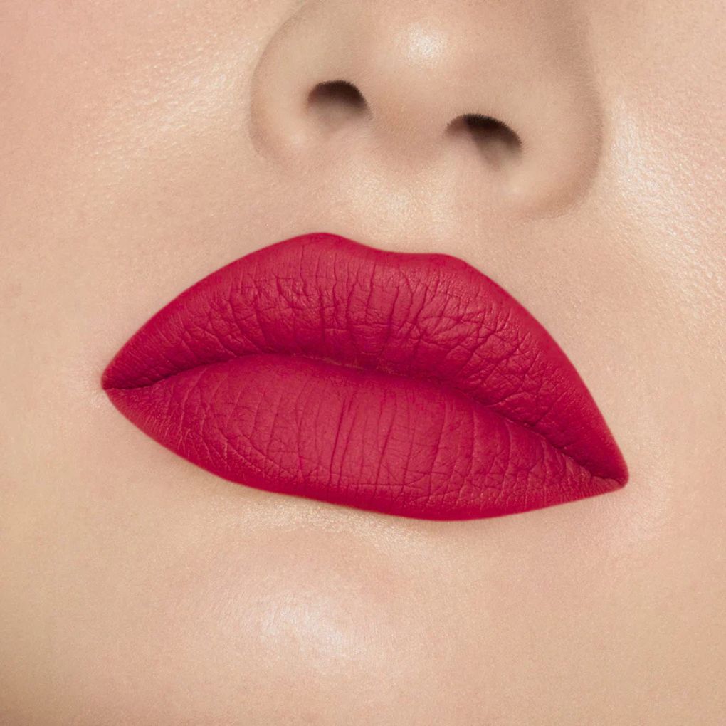 Close-up of model wearing oplenza Icon Matte Lipstick in shade 23 Ruby Icon, best matte lipstick for dry lips