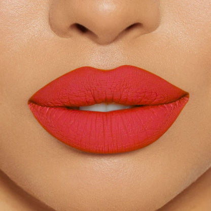 Close-up of model wearing oplenza Icon Matte Lipstick in shade 24 Coral Icon, best matte lipstick that stays on