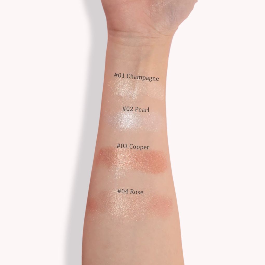 A close-up of an arm swatch with four makeup shades: Champagne, Pearl, Copper, Rose. Best makeup highlighter 