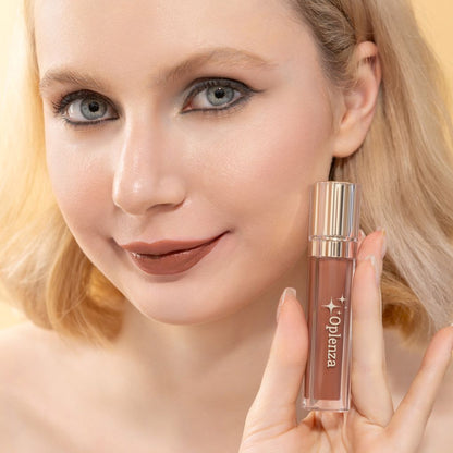Woman holding a lip gloss with 'Oplennza' branding against a neutral background, Bare Infinity
