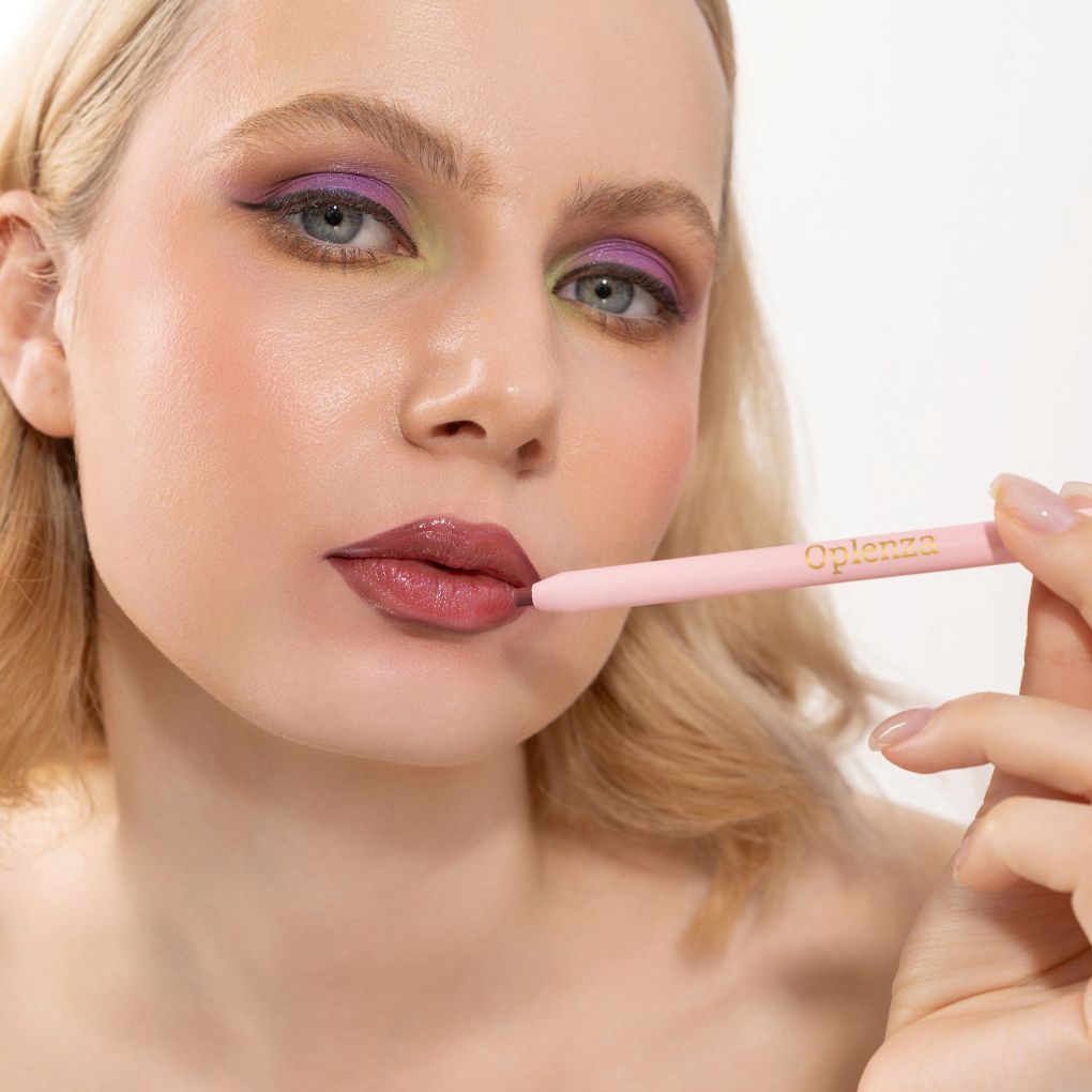 An elegant woman wearing and showcasing the vegan, luxury and cruelty free oplenza Define & Refine Lip Liner in the color Berry Bold