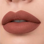 Close-up lip swatch of Oplenza Matte-to-Shine Lip Duo in Brownie with a matte finish.