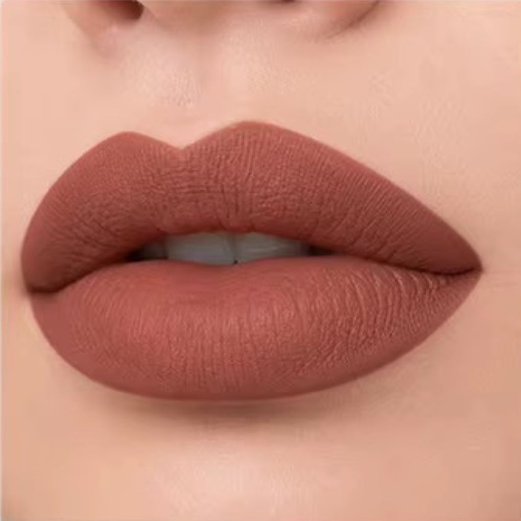Close-up lip swatch of Oplenza Matte-to-Shine Lip Duo in Brownie with a matte finish.