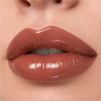 Close-up lip swatch of Oplenza Matte-to-Shine Lip Duo in Brownie with a glossy finish.