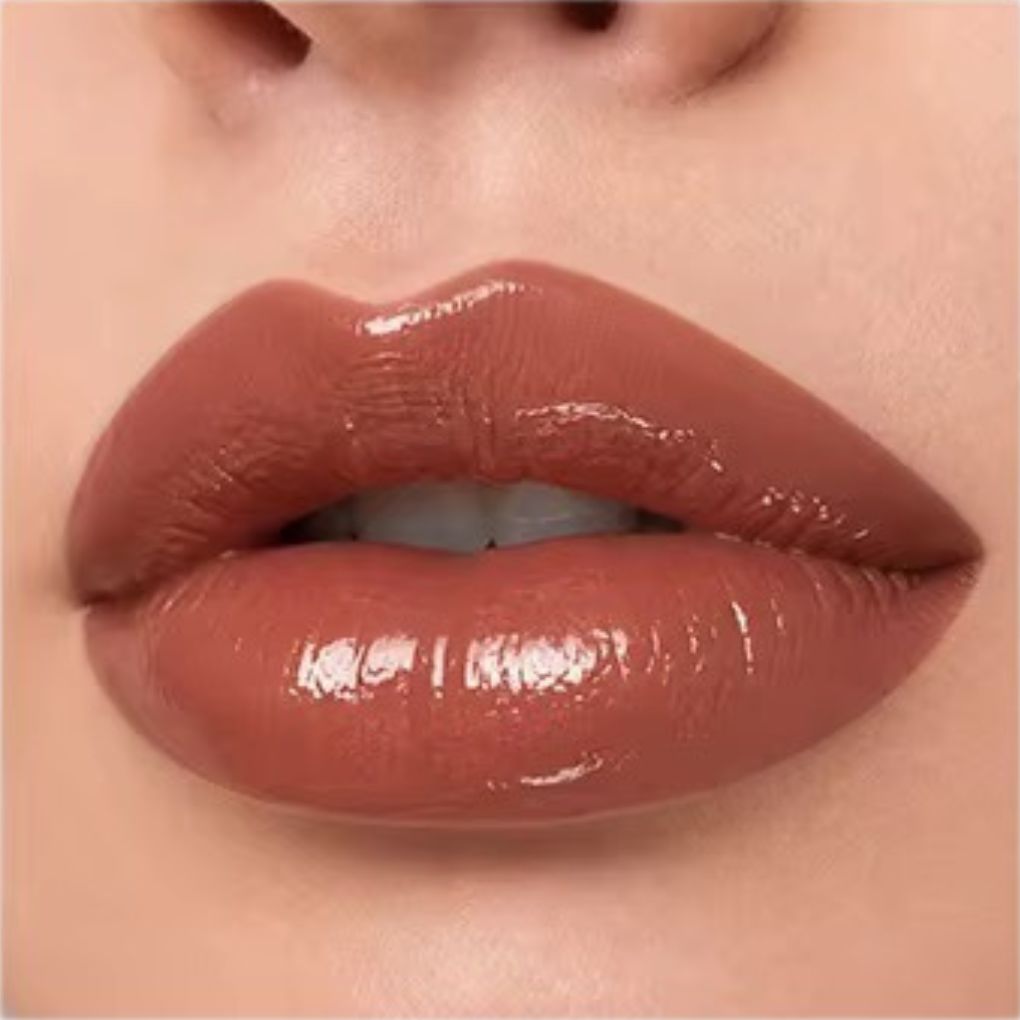 Close-up lip swatch of Oplenza Matte-to-Shine Lip Duo in Brownie with a glossy finish.