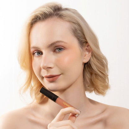 A Woman wearing and showcasing the elegant Oplenza Signature Velvet Liquid Lipstick in the color Cashmere Clay