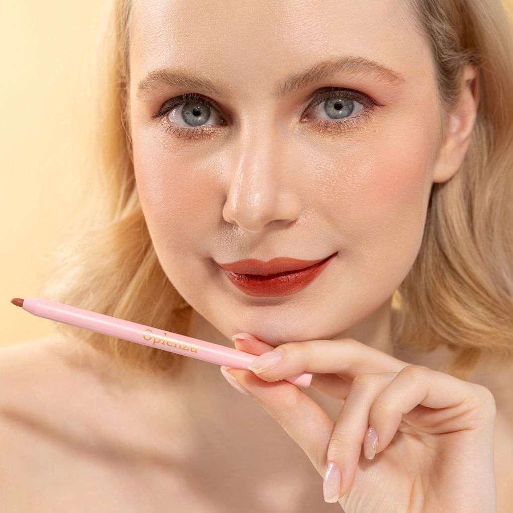 An elegant woman wearing and showcasing the vegan, luxury and cruelty free oplenza Define & Refine Lip Liner in the color Cocoa Rouge