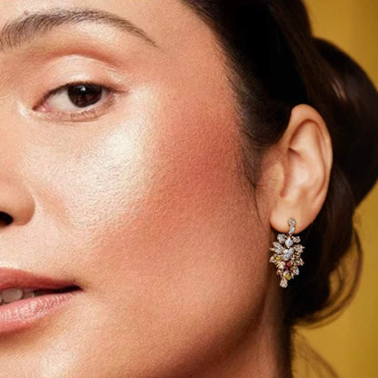 Woman wearing and showcasing the effect of oplenza opulent Light Luminizer in shade Coralia