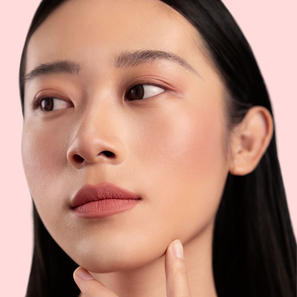 Woman wearing and showcasing the effect of oplenza Velvet Whip cream blush in shade Dusty Veil