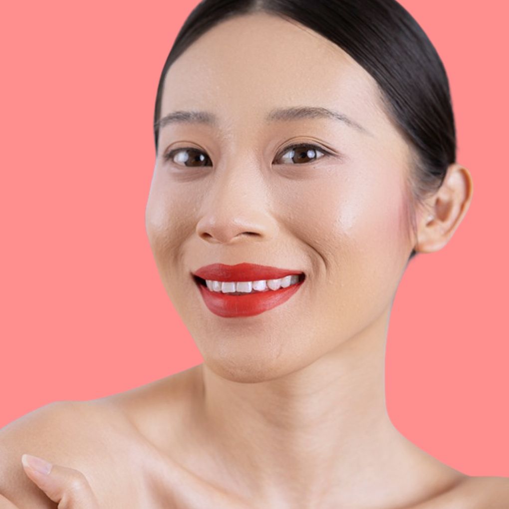 Woman wearing and showcasing the effects of the best cruelty-free Oplenza Signature Matte Lipstick in shade Fiery