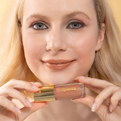 A woman wearing and showcasing the best cruelty-free, vegan, shiny and hydrating lip gloss in shade Glow