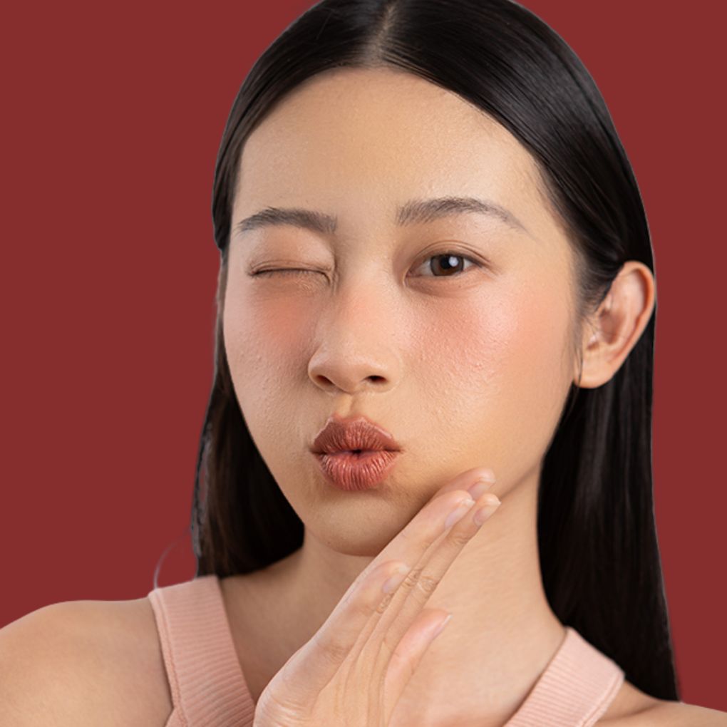 Woman wearing and showcasing the effects of the best cruelty-free Oplenza Signature Matte Lipstick in shade Graceful