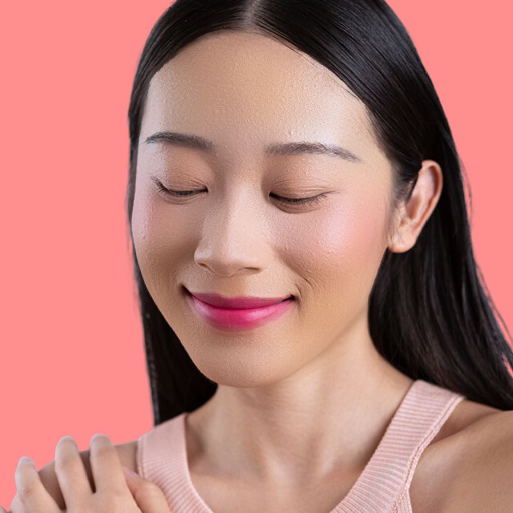 Woman wearing and showcasing the effects of the best cruelty-free Oplenza Signature Matte Lipstick in shade Joyful