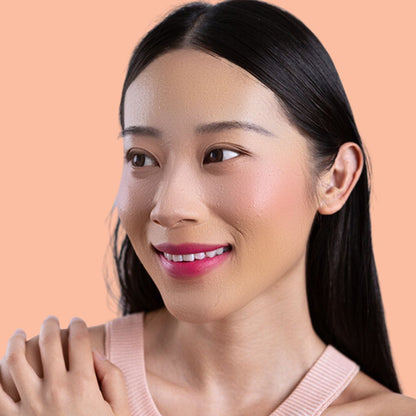 Woman wearing and showcasing the effects of the best cruelty-free Oplenza Signature Matte Lipstick in shade Joyful