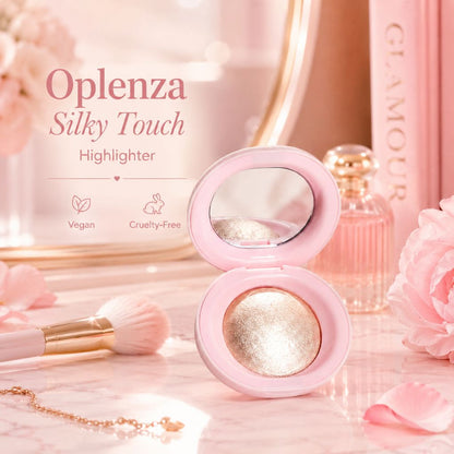 An open pink Oplenza Silky Touch Highlighter compact sits on a marble surface with pink flowers, a makeup brush, and a perfume bottle in a soft, styled beauty setting.
Shades: Champagne, Pearl, Copper, Rose.
