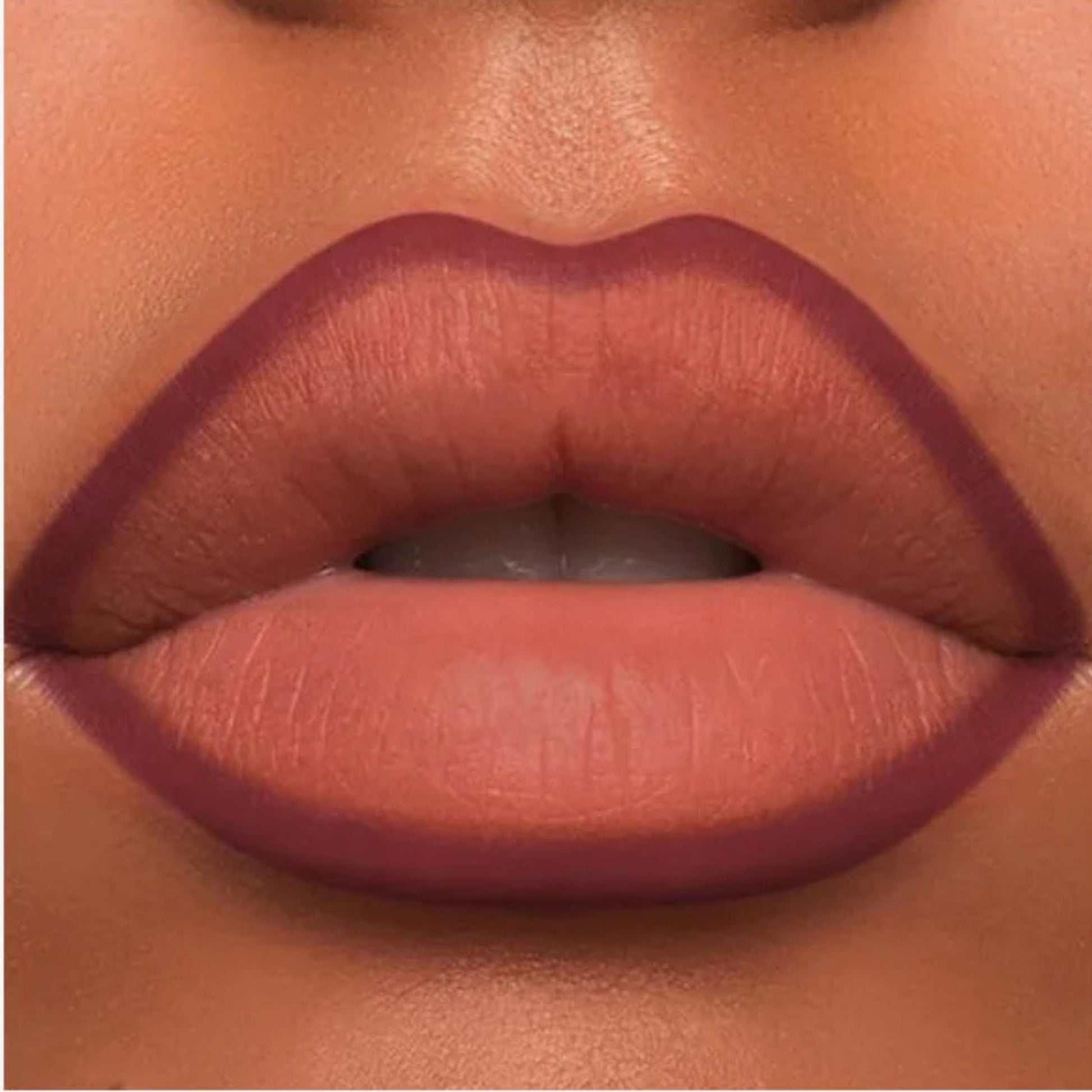 A close-up of the Oplenza Velvet Whisper Lip Liner effect on a woman's lips in the shade Bordeaux Seduction