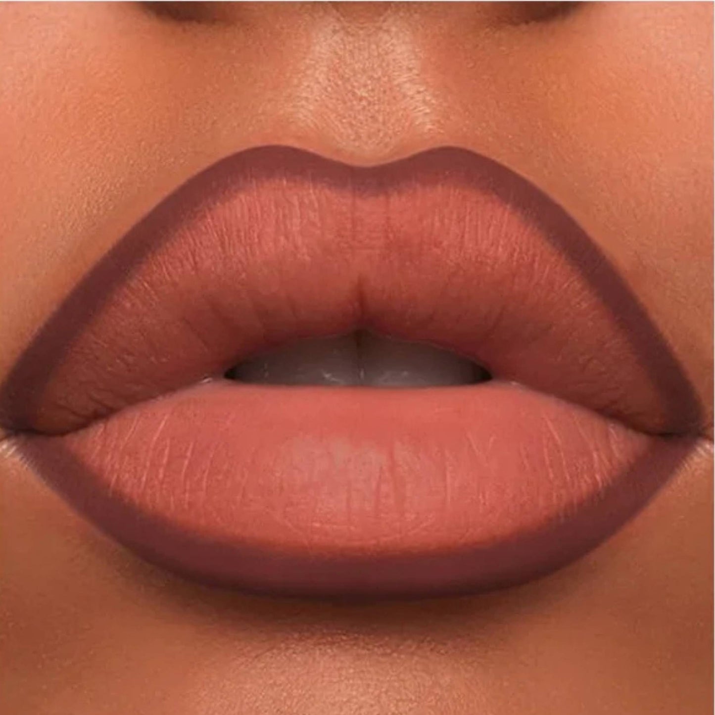 A close-up of the Oplenza Velvet Whisper Lip Liner effect on a woman's lips in the shade Midnight Merlot