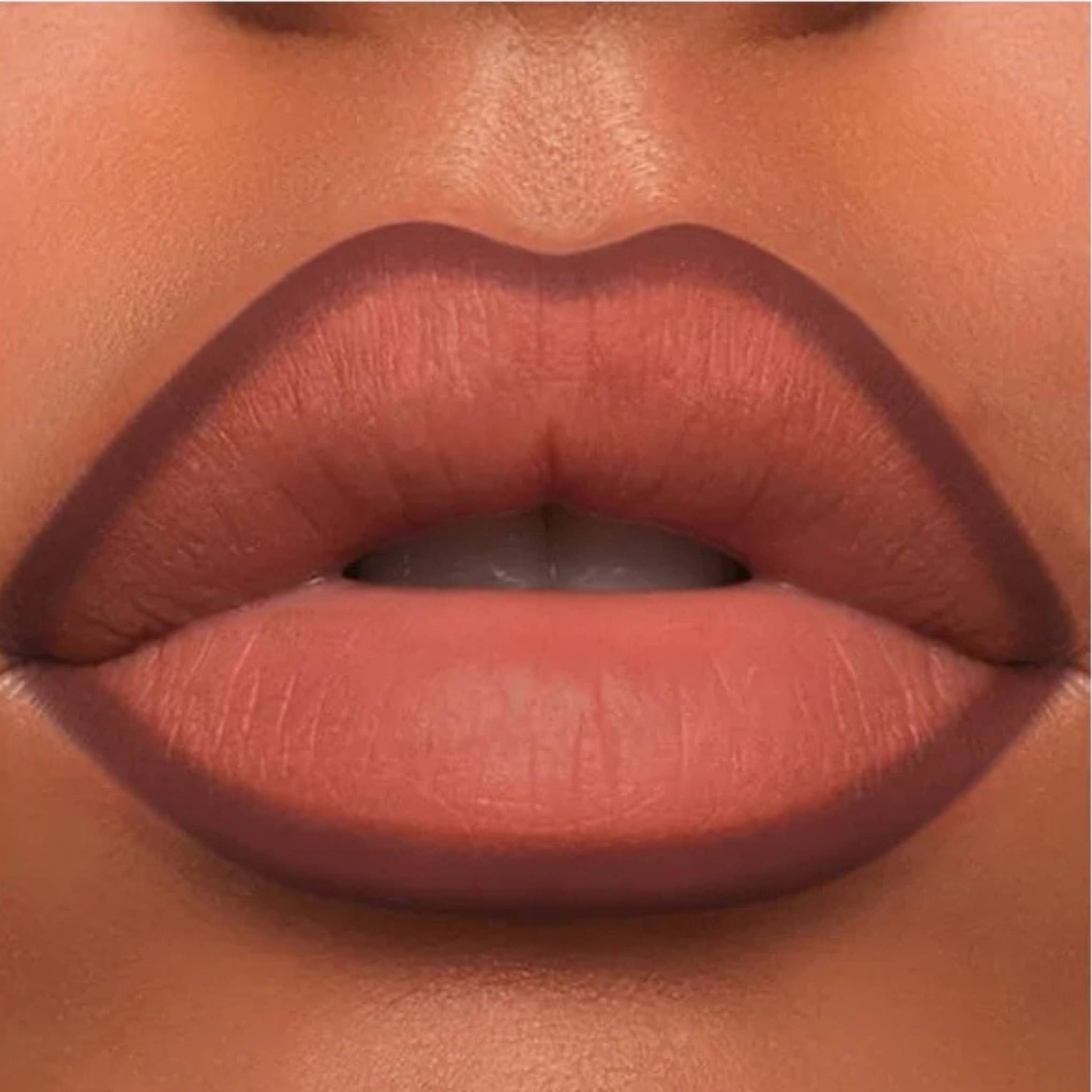 A close-up of the Oplenza Velvet Whisper Lip Liner effect on a woman's lips in the shade Midnight Merlot