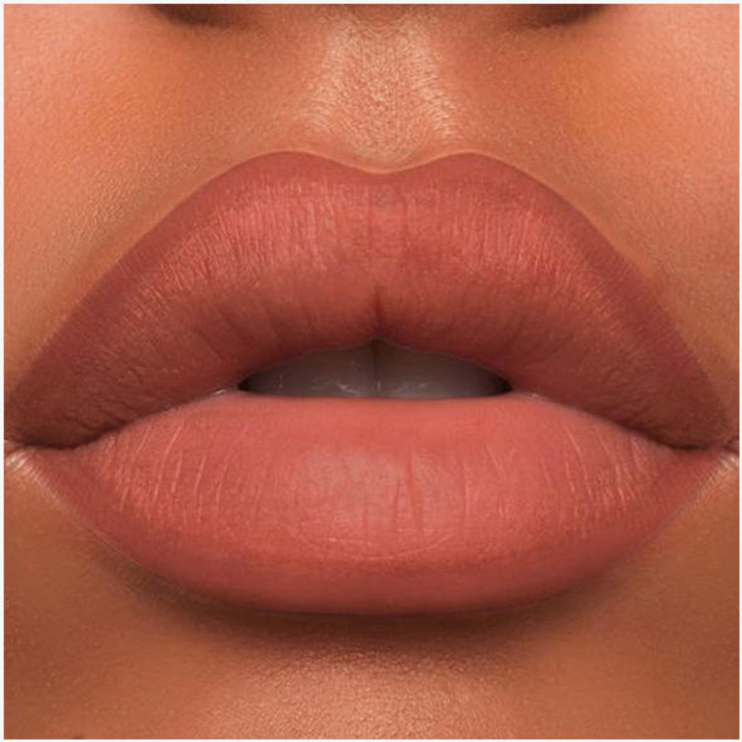 A close-up of the Oplenza Velvet Whisper Lip Liner effect on a woman's lips in the shade Sahara Dusk