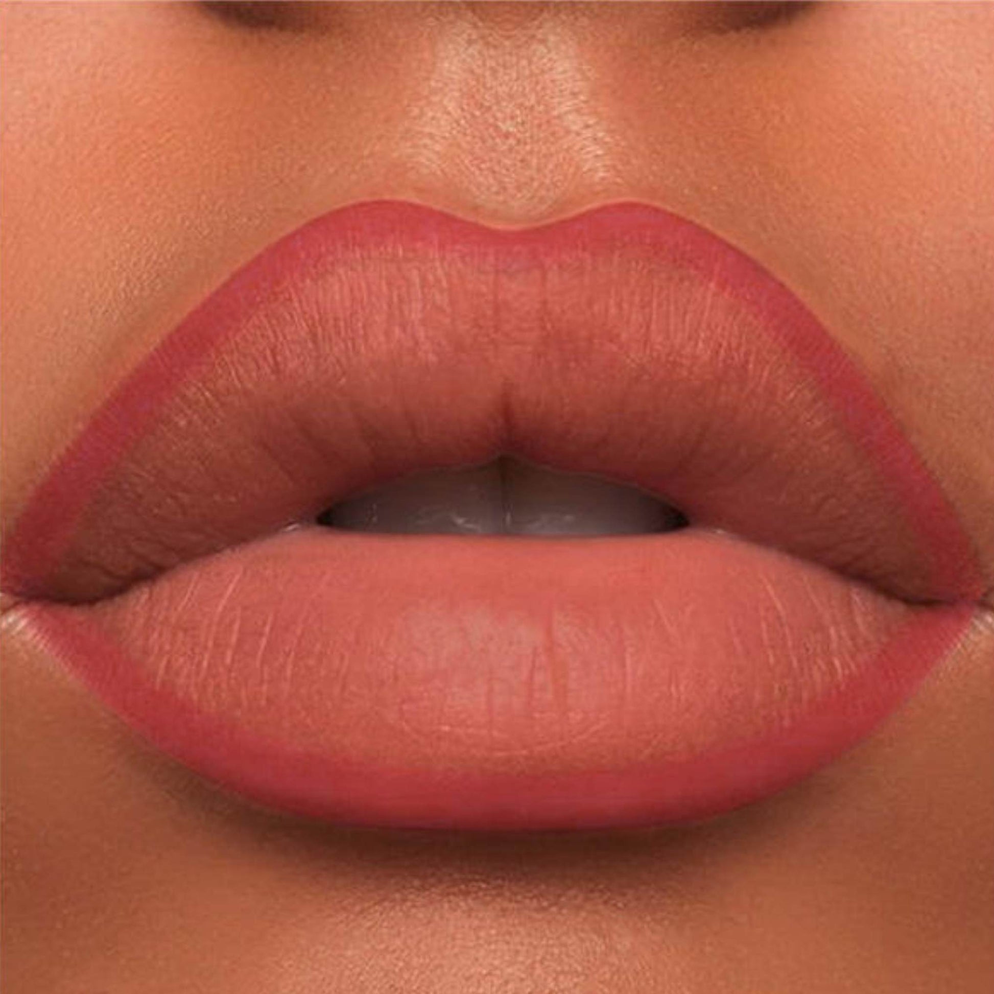 A close-up of the Oplenza Velvet Whisper Lip Liner effect on a woman's lips in the shade Sunset Amber