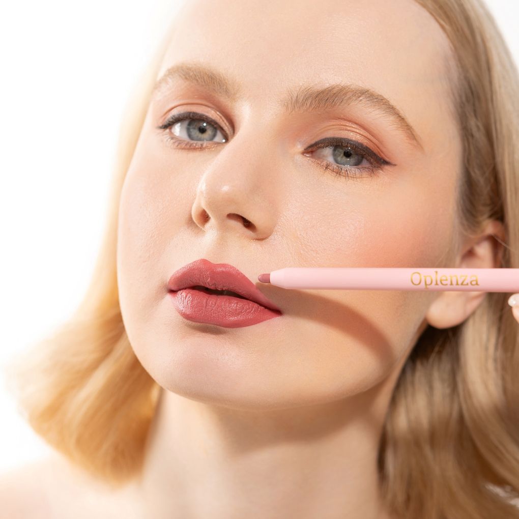 An elegant woman wearing and showcasing the vegan, luxury and cruelty free oplenza Define & Refine Lip Liner in the color Muted Plum