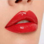 Close-up lip swatch of Oplenza Matte-to-Shine Lip Duo in Noir Red with a glossy finish.