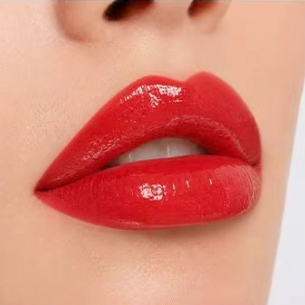 Close-up lip swatch of Oplenza Matte-to-Shine Lip Duo in Noir Red with a glossy finish.