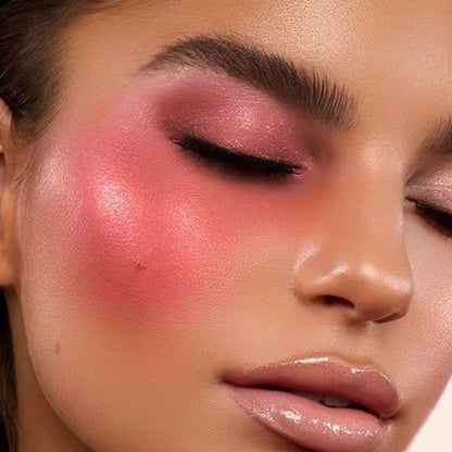 Woman wearing, showcasing on her face the Oplenza Luminous Pressed Powder Blush in shade Passion