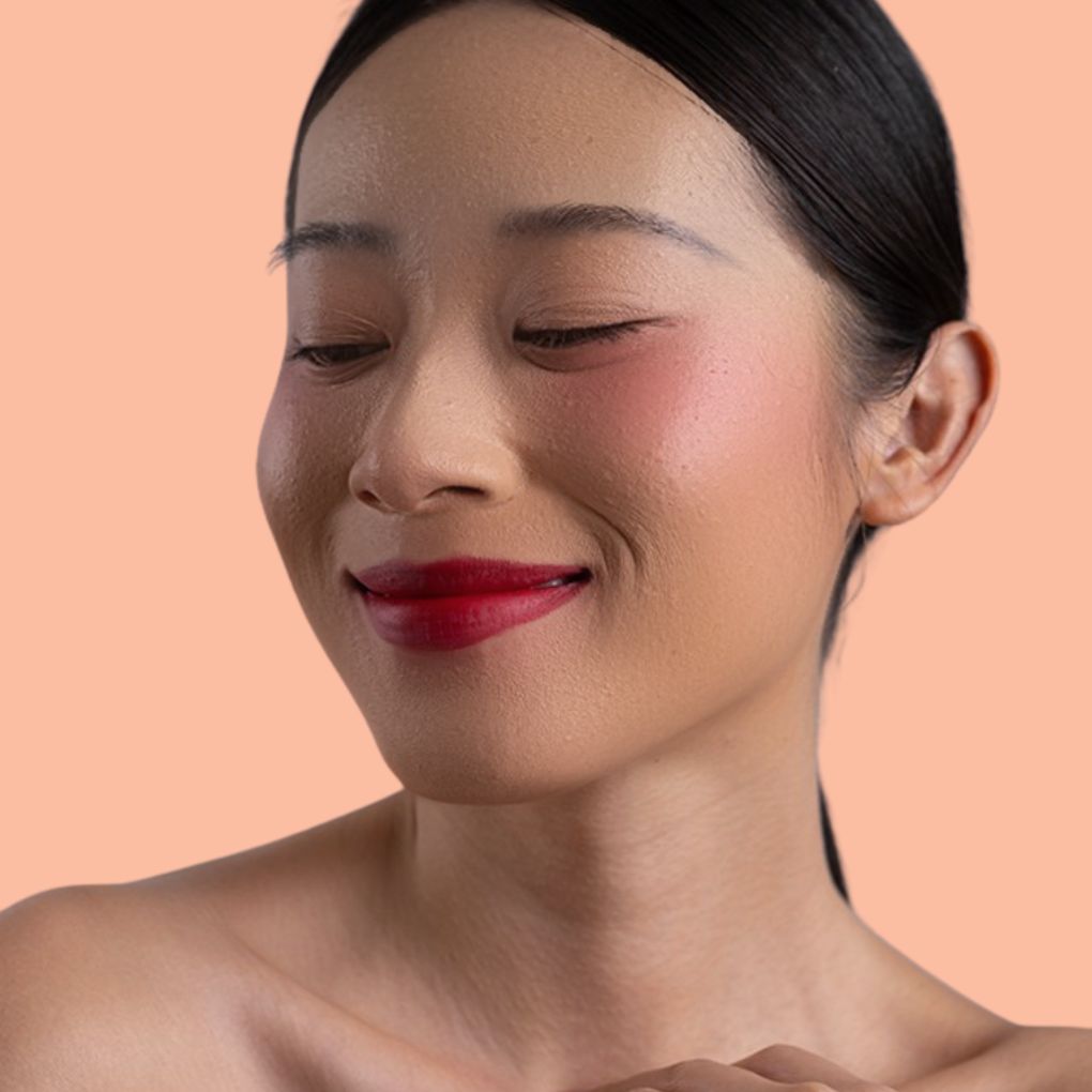 Woman wearing and showcasing the effects of the best cruelty-free vegan Oplenza Signature Matte Lipstick in shade Passionate