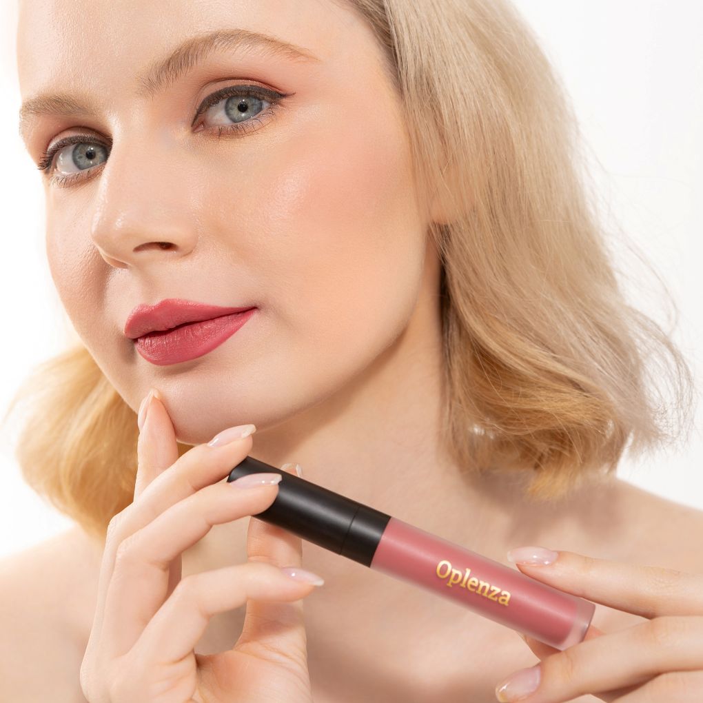 A Woman wearing and showcasing the elegant Oplenza Signature Velvet Liquid Lipstick in the color Petal Silk