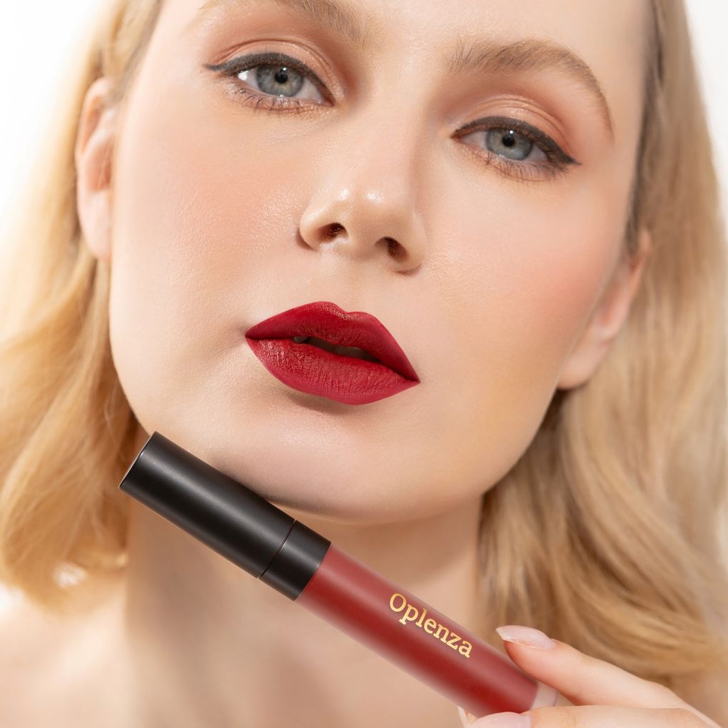 A Woman wearing and showcasing the elegant vegan Oplenza Signature Velvet Liquid Lipstick in the color Plum