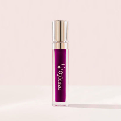Purple lip gloss with golden cap on a light pink background