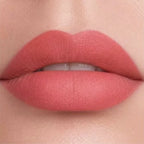 Close-up lip swatch of Oplenza Matte-to-Shine Lip Duo in Ripe Peach with a matte finish.