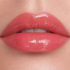 Close-up lip swatch of Oplenza Matte-to-Shine Lip Duo in Ripe Peach with a glossy finish.