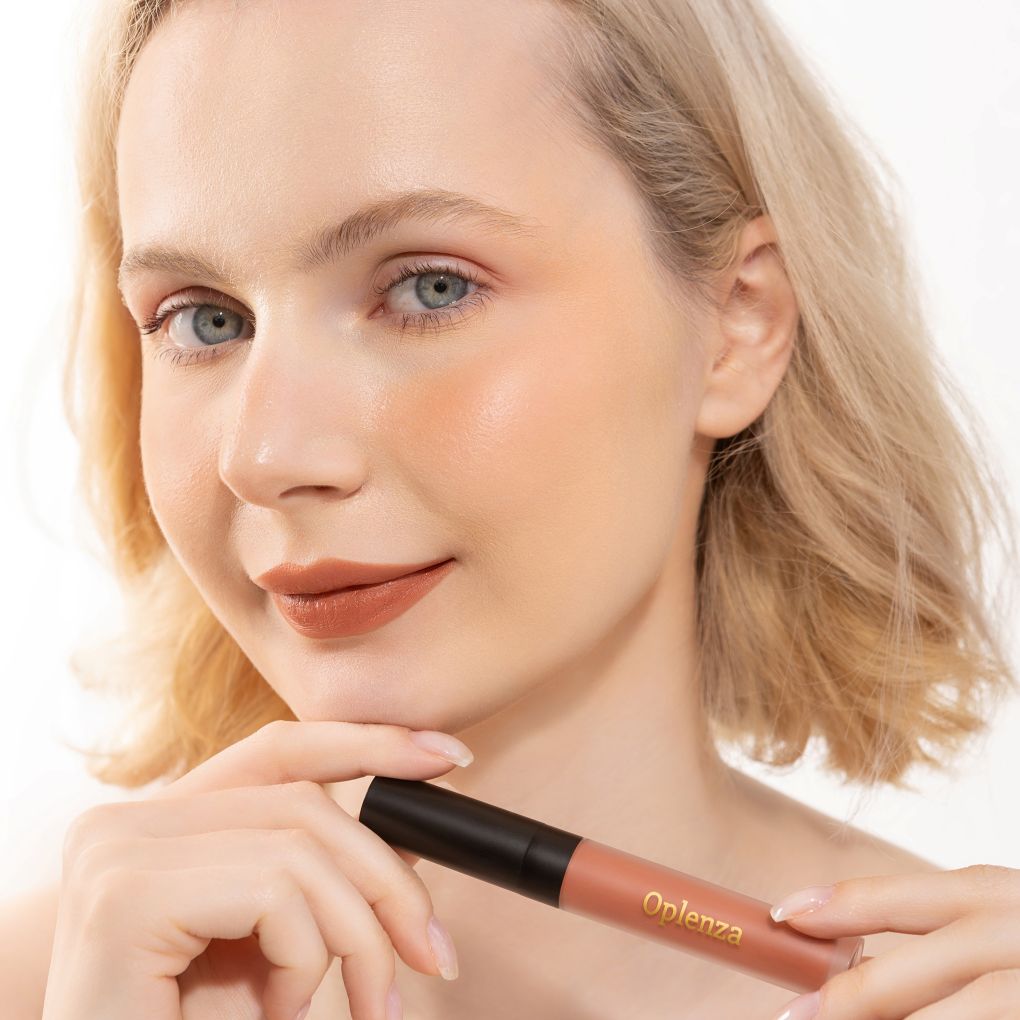 A Woman wearing and showcasing the elegant Oplenza Signature Velvet Liquid Lipstick in the color Rose Drape
