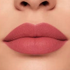 Close-up lip swatch of Oplenza Matte-to-Shine Lip Duo in Rosewood with a matte finish.