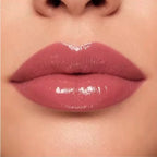 Close-up lip swatch of Oplenza Matte-to-Shine Lip Duo in Rosewood with a glossy finish.