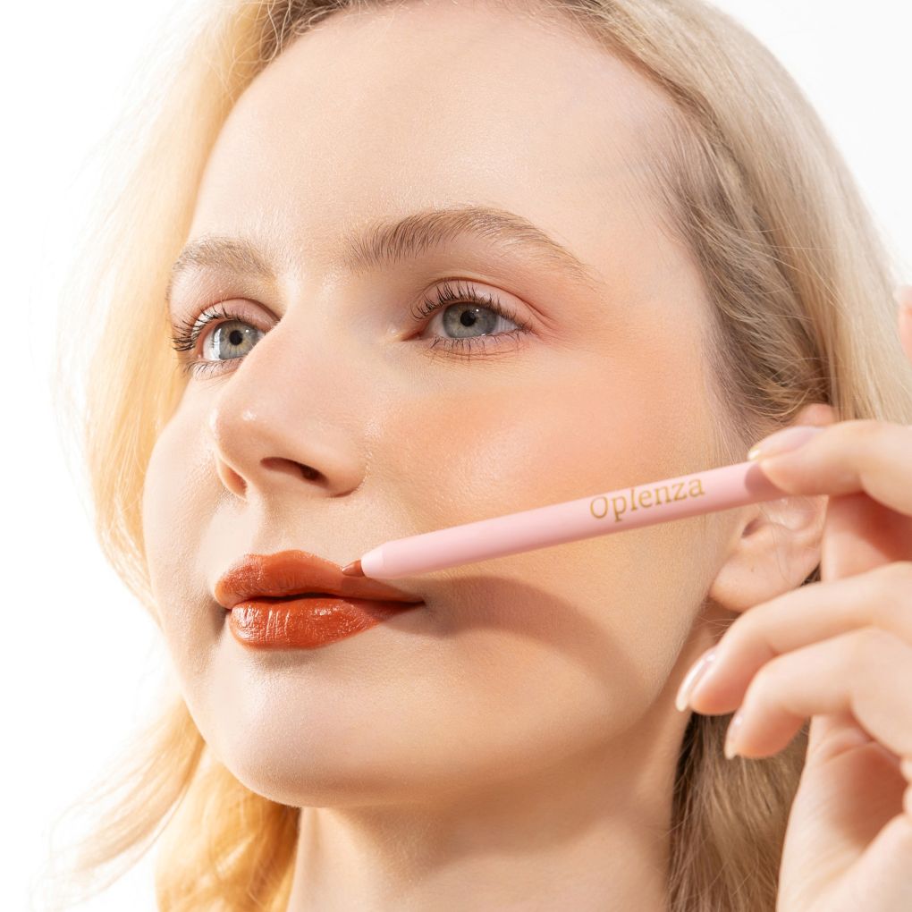 An elegant woman wearing and showcasing the vegan, luxury and cruelty free oplenza Define & Refine Lip Liner in the color Rust Bloom