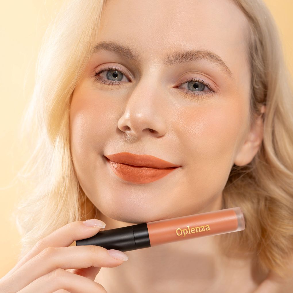 A Woman wearing and showcasing the elegant cruelty free Oplenza Signature Velvet Liquid Lipstick in the color Satin Sand
