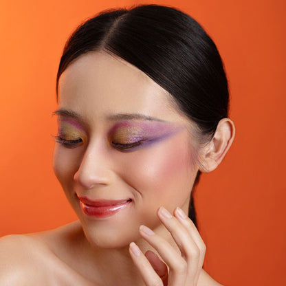 Woman showcasing oplenza eyeshadow palette effect, radiant, colorful in shade Solara Flare