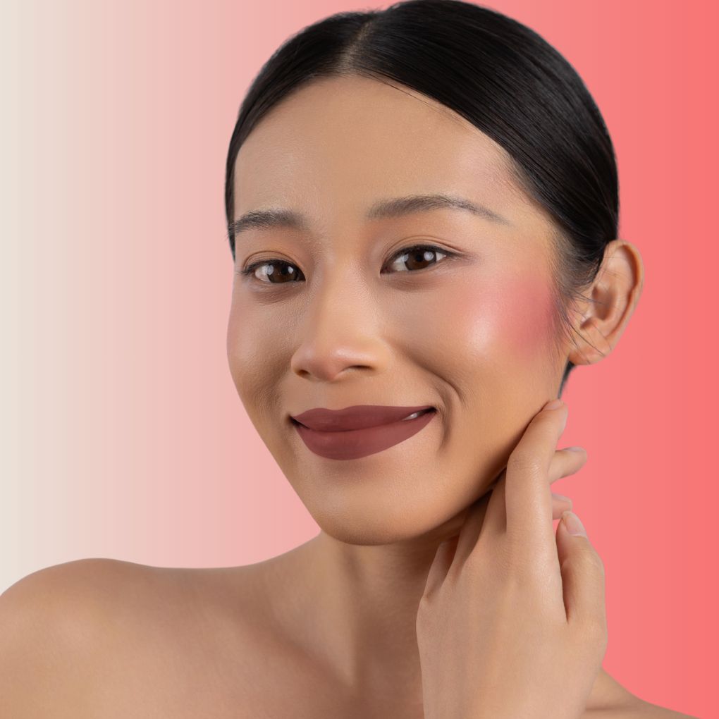 An elegant woman wearing and showcasing the vegan, luxury and cruelty free oplenza Define & Refine Lip Liner in the color Spiced Chestnut