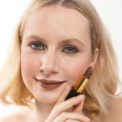 Woman applying and showcasing the effects of the best cruelty-free Oplenza Signature Matte Lipstick in the Tender shade.